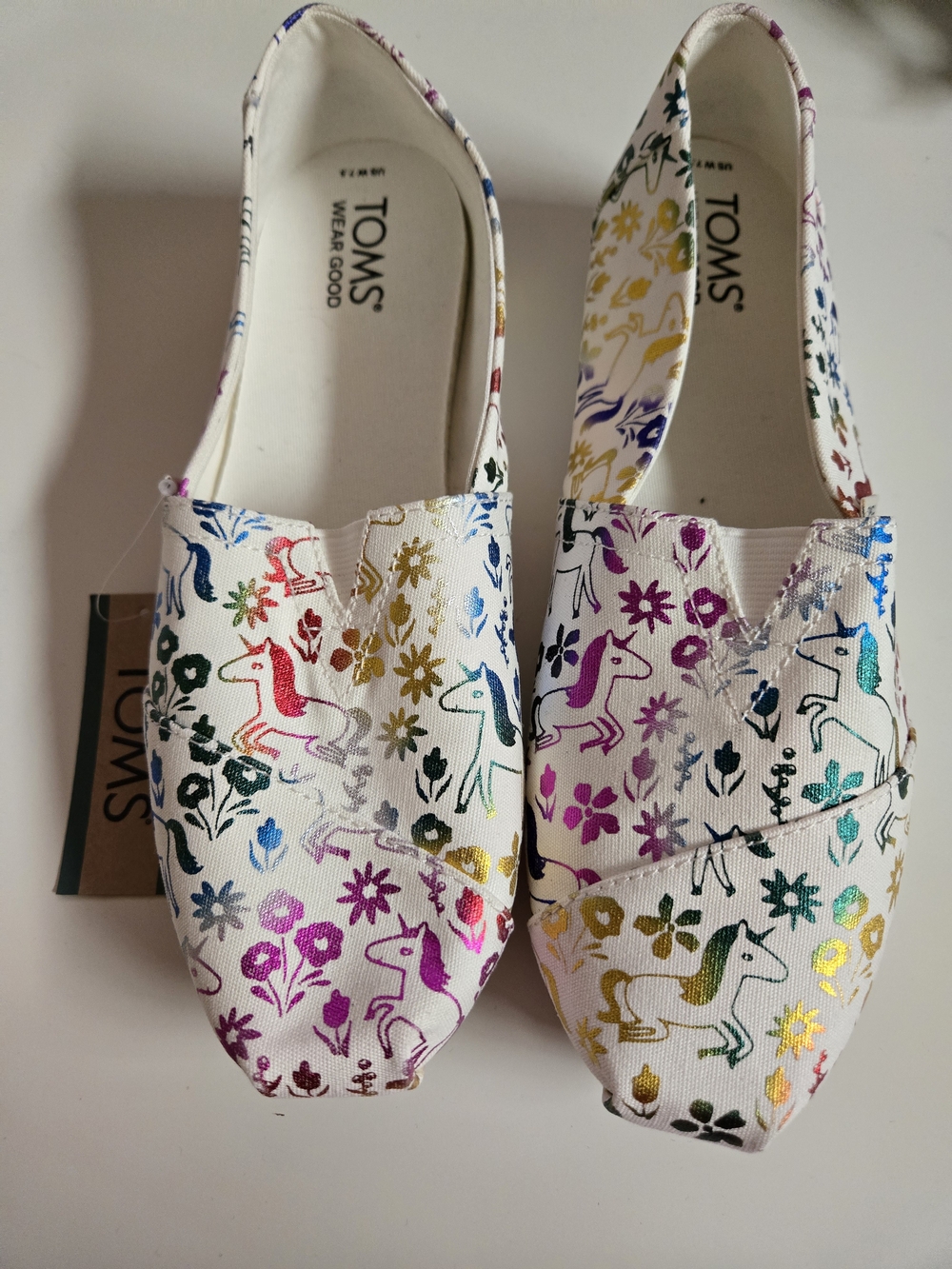 TOMS White Canvas Slip-Ons with Rainbow Unicorn Print